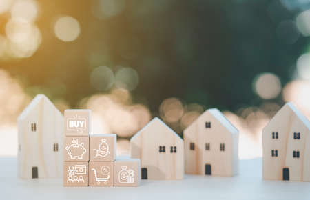 Mini wood house model from model on wood table in the nature background , Planning buy Real Estate, Planning to buy property and Choose the best. work from home and stay at home concept.の写真素材