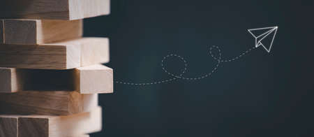 Blocks wood game with copy space, The tower from wooden blocks from the top view, Jenga, Businessman manage his strategy, Concept of education, risk, development, and growthの写真素材