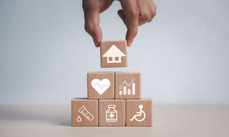 Wooden blocks with icons of various types of insurance, icons healthcare medical symbol on wooden block , Healthcare and medical Insurance concept, inscription word sos on wooden cubesの写真素材