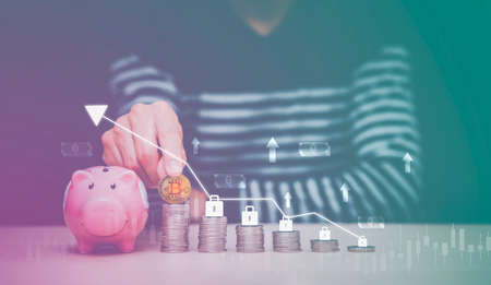Businessman is hold bitcoin on Coins stack of a business network on background. bitcoin cryptocurrency ideas concept and virtual financial chart diagram, Digital symbol of a new virtual currencyの写真素材