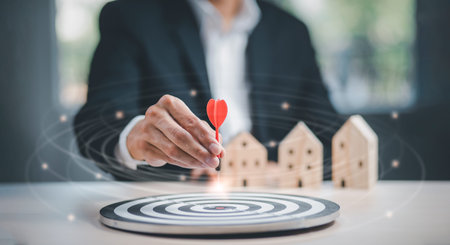 Targeting the business and home concept, Businessman throwing red arrow dart to virtual target dart...