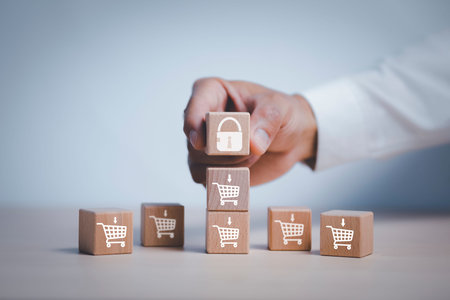 Hand hold cubes woods key block step on table with icon shopping cart on the White background,...
