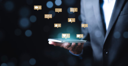 Businessman holding tablet with communication message icons of mail, Marketing business sending information to customers, Customer service call center contact us. Email marketing and newsletter.の写真素材