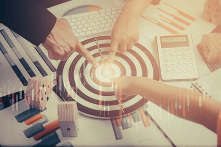 Concept financial transactions online, Group business and point at financial analyzing data while discussion, Businesspeople Point darts aiming at the target center business,Targeting the business.の写真素材