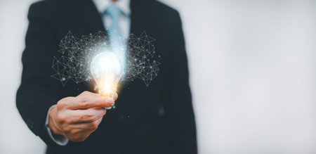Double exposure of business hand holding light bulb with line connect and working on desk,...