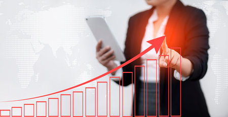 Businesswoman touch growth graph losses arrow on the stock market chart concept, Business use pen...