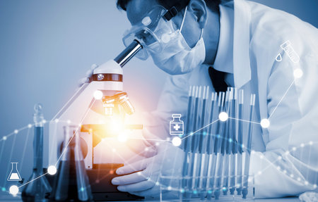 biochemical research scientist working with a microscope for the virus,Doctor man write a history of the experimental results in a , laboratory glassware containing chemical liquid for design.の写真素材