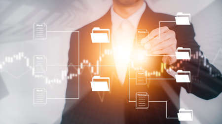 Businessman hand touch folder of document Management System,  online documentation database and process automation to efficiently manage files work, knowledge, Corporate business technology.の写真素材