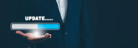 Businessman hand hold bar of Update Software Computer Program Upgrade Business Technology Internet, Update on virtual screen. Internet and technology concept, loading bar with installing the update.の写真素材