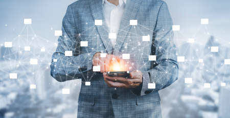 Businessman hand holding e-mail icon letter on a touch screen interface, virtual postal envelope, concept of spam email, internet and networking, Contact us newsletter email and protect your personal.の写真素材