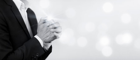 Businessman hand praying and worship to GOD Using hands to pray on the white Background, worship, hands in prayer concept for faith, spirituality and religion, hands raised in worship background.の写真素材