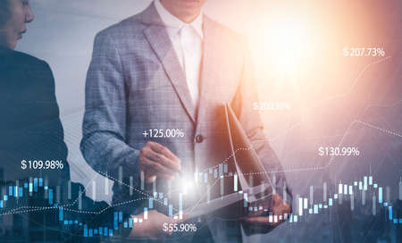 Meeting and financial transactions online, businessman holding pen and point at financial analyzing data while discussion, planning brand promotion budget, raising company awareness in social mediaの写真素材