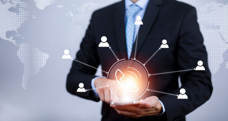 Businessman holding telephone icon and  HR Human, people icon on the graph Screen of communication,...