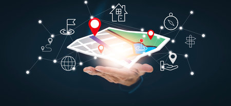 Businessman hand holding virtual world and model map with location point , GPS app, icon Travel maps...