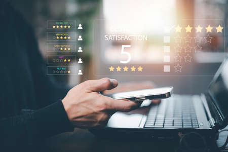 Man touch smartphone with Customer review satisfaction feedback survey concept, User give rating to service experience on online application, service leading to reputation ranking of business.の写真素材
