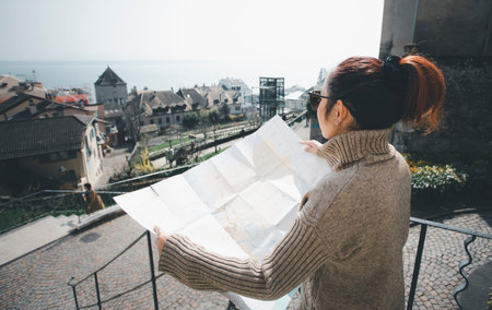 Woman hand hold map city for travel and model map with location point , GPS app, icon Travel maps...