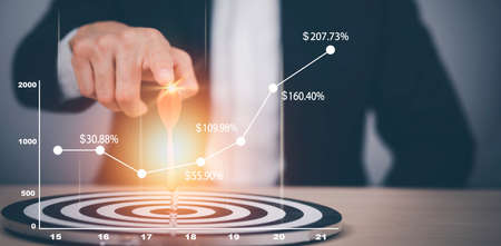 Targeting the business concept, Businessman hand holding red dart to the virtual target dartboard, Executive marketing, investment goal and target for business investment concept,の写真素材