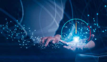 Fast internet connection with Metaverse technology concept, Hand holding smartphone and Virtual screen of Internet speed measurement,Internet and technology concept, 5G Hi speed internet conceptの写真素材
