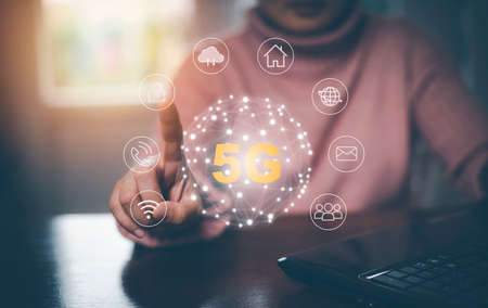 Global network connection 5G on hand woman.Global network connection 5G with icon concept, technology network wireless systems and internet of things, new technologies coming up in the future.の写真素材