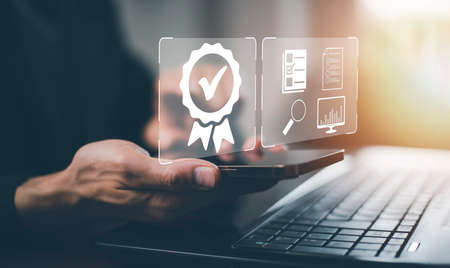 Quality assurance of business services, Smart phone with shows the sign of the top service Quality assurance in Black background , Guarantee, Standards, ISO certification and standardization concept.の写真素材