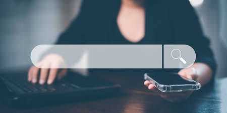 Searching Browsing Internet Data Information with blank search bar. man's hands are using smartphone and keyboard to Searching for information. Using Search Console with your website.の写真素材