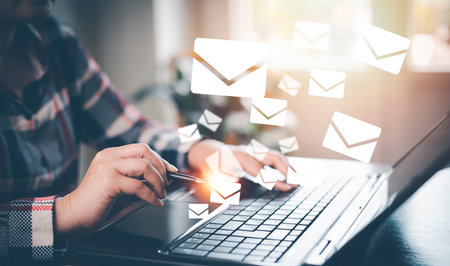 woman holding smartphone with communication icons, letter icon, email icons, and newsletter email and protect your personal information or spam mail, Customer service call center contact.の写真素材