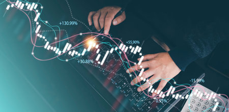 Businessman interacting with laptops, phones, and tablets with featuring stock tickers or graphs,...