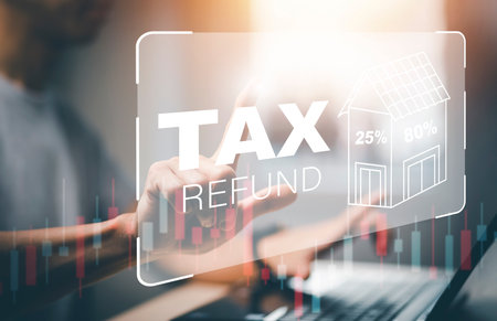 Hand using tablet with bar  TAX REFUND and refund tax of duty taxation business, graphs and chart being demonstrated on the screen media,  tablet pc and selecting tax refund.の写真素材