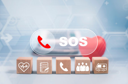 Wooden cubes with button Emergency icon concept, Chat message icon, Emergency application from smartphone for elderly, technology concept.Old hand touch mobile phone and call for help.の写真素材
