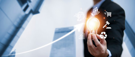Double exposure of business hand holding light bulb with line connect and working on desk,...