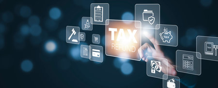 Hand touch with bar TAX REFUND and refund tax of duty taxation business, graphs and chart being demonstrated on the screen media,  tablet pc and selecting tax refund.の写真素材