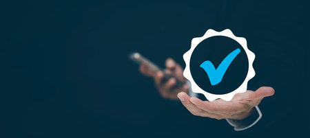 Quality assurance of business services, Businessman Hand shows the sign of the top service Quality assurance in Black background , Guarantee, Standards, ISO certification and standardization concept.の写真素材