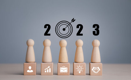 2023 with square wood and icon on white background, Money spending planning, plant growing up on...