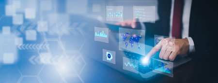Businessman interacting with laptops, phones, and tablets with featuring stock tickers or graphs,...