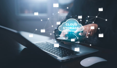 Businessman hand holding smartphone and laptop with cloud computing diagram show on hand. Cloud...
