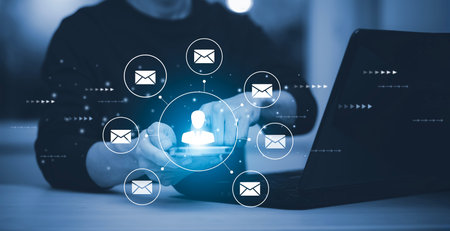 Businessman holding smartphone with communication icons, letter icon, email icons, and newsletter email and protect your personal information or spam mail, Customer service call center contact.の写真素材