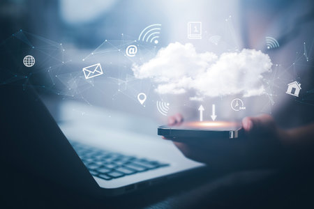 Businessman hand holding smartphone and laptop with cloud computing diagram show on hand. Cloud...