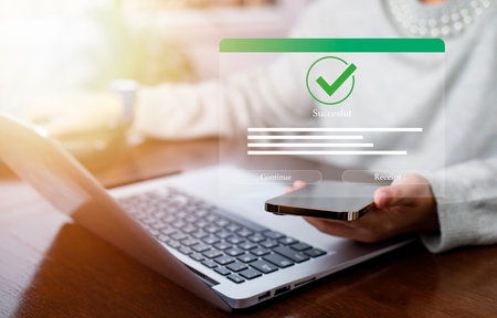 Smartphone and Laptop with Online payment ,Hand touch banking online bill payment Approved concept button, credit card and network connection icon on business technology virtual screen backgroundの写真素材