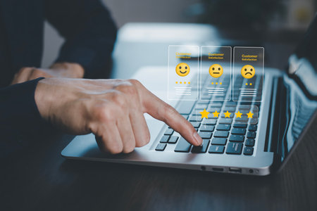 Businessman pressing smile on laptop keyboard customer service, evaluation concept,rating to service experience on online application, Customer review satisfaction feedback survey,Negative feedbackの写真素材