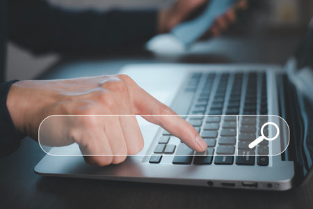 Laptop and Data Search Technology Search Engine Optimization, Business people hands typing on laptops or computer keyboards to search for information, internet to search for information on web browserの写真素材