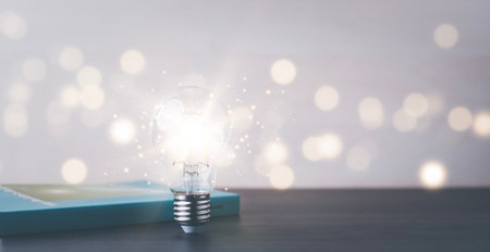 Thinking and creative concept, Light bulb on the Book and light bulb style bokeh vintage dark...