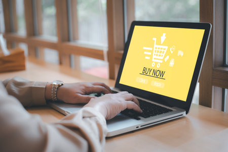 Online shopping with laptop computer concept, Hand hold smartphone and laptop for online shopping showing payment details, E-commerce shop ecommerce website with smartphone shopping cart onlineの写真素材