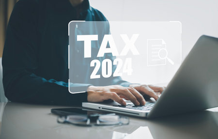 Concept TAX-2024 and refund tax of duty taxation business, graphs, and chart being demonstrated on the screen media, App for selecting tax refund, Keeping track of annual tax expendituresの写真素材