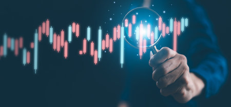 Ideas and perspectives, Stock investment stock market for analysis technical grap. Businessman hand holding magnifying glass with virtual stock market chart, Business investment earning income conceptの写真素材