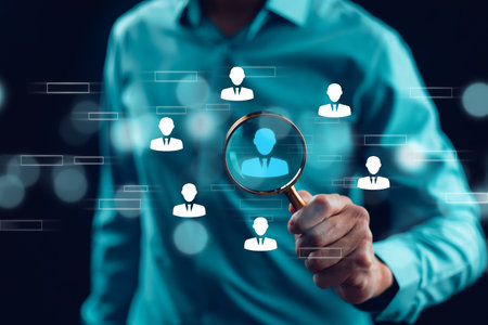 Human Resource Management HRM concept. Businessman holding magnifier for searching to human icons for human development and recruitment concept.の写真素材