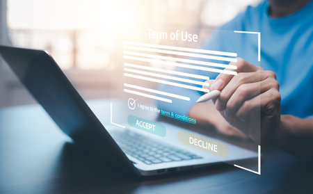 Man using a laptop with a graph of Terms of use concept, online banking check budget planning concept banner for website header design,Terms of use business concept. Terms and conditions of contract.の写真素材