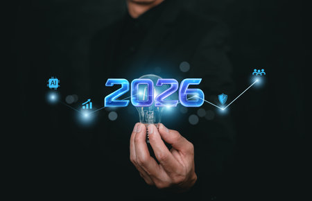 Future technology and innovation concept with hand holding glowing 2026 symbol, connected digital...