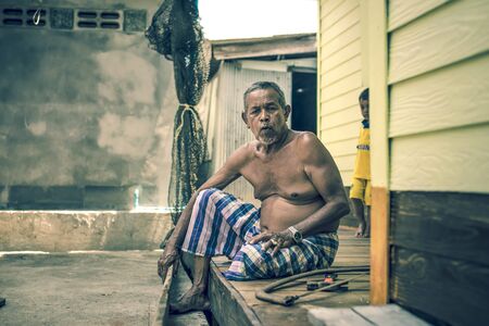 The old man was repairing his wooden bed,  [Panyee Island, Phang-nga, Thailand  5-Apr-2015]のeditorial素材