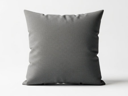 This image features a single, square gray cushion with a textured surface, isolated against a white background. The cushion appears to be made of a soft fabric and is centrally positioned in the image. The white background enhances the visibility of the cushion, making it the focal point of the photograph.の素材