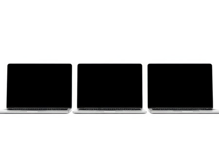 This image features three laptops arranged in a row on a white background. The laptops are closed and positioned side by side, creating a neat and organized appearance. The image is ideal for use in presentations, web design, or marketing materials related to technology and computing.の素材